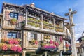 Stone cross and typical architecture in main square of La Alberca.Spain