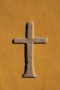 Stone cross walled in a orange wall Royalty Free Stock Photo
