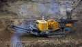 Stone crusher and crane in working Royalty Free Stock Photo
