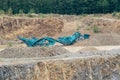 Stone crusher in the quarry. Working mining machine - stone crusher. Quarrying of stones for construction works. Mining industry.