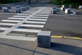 Stone cubes barriers as protection of a nice lawn cube cubes on a paved sidewalk platform of a tram protected from the entry of ca Royalty Free Stock Photo