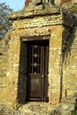 Stone curve Ruins wall with decorate iron door Royalty Free Stock Photo