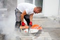 Stone cutter at work on construction site. Royalty Free Stock Photo