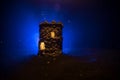 Stone defence tower at night. Medieval castle miniature with toned foggy backlight. Creative table decoration