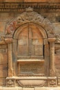 Stone door frame showing mythical creatures in Patan, Nepal