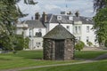 Stone dovecot in front of a white building in Scotland