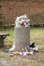 Stone dustbin full of garbage which has not been emptied. Dustman service is not working after festival being finished