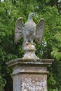 A stone eagle on a square plinth stands guard over an English country house Royalty Free Stock Photo