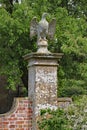 A stone eagle on a square plinth stands guard over an English country house Royalty Free Stock Photo