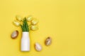 Stone Easter eggs and bouquet of beautiful yellow tulips. Minimal style composition with Easter design concept