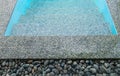 Stone on the edge of the swimming pool Royalty Free Stock Photo