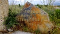 The stone at the entrance to the Peace Park in the village of Aptera with the word Peace written in different languages