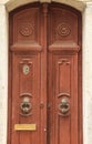 Stone facade with old red wooden door Royalty Free Stock Photo