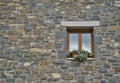 Stone facade with window detail decorated with white flowers