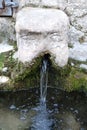 Stone face fountain with water in detail Royalty Free Stock Photo