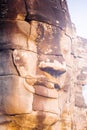 Stone face statue in ancient Bayon Temple Angkor Thom, Cambodia. Royalty Free Stock Photo