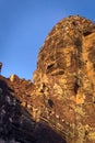 Stone face tower at Bayon temple, located in Angkor, Cambodia, the ancient capital city of the Khmer empire. View from the western Royalty Free Stock Photo