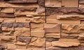 Stone facing of facades and walls.The wall is made of decorative facing stone, such as Sandstone or slate. The texture Royalty Free Stock Photo