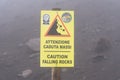 stone fall warning sign on a foggy day on the pedestrian path to the top of the mount vesuvio volcano.  Naples, Italy. Royalty Free Stock Photo