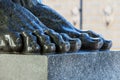 Atlant`s legs. Stone feet of the atlant close-up