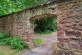 Stone fence with an arch entrance to a Jewish cemetery in Frankfurt, Germany