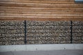 Stone fence in front of wooden house