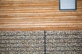 Stone fence in front of wooden house