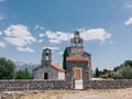 Stone fence with a gate near the ancient church of the Holy Trinity. Budva, Montenegro Royalty Free Stock Photo