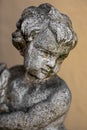 Stone figure of a child against blurred background