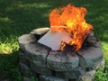 Stone fire pit burning household trash