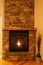 Stone fireplace with gas logs on a cold, winter night. Royalty Free Stock Photo