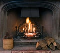 Stone fireplace with a lit roaring fire