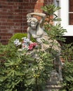 Stone flower pot with bare breasted beautiful woman sculpture in a garden in Bethany, Oklahoma. Royalty Free Stock Photo