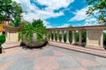 Stone flowerpot with flowers on the terrace with railings and balustrades. Royalty Free Stock Photo