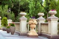 Stone flowerpots with flowers on pedestals. Royalty Free Stock Photo