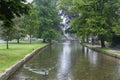 Stone footbridge across the River Windrush in Bourton-on-the-Water, also known as The Venice of the Cotswolds - Gloucestershire - Royalty Free Stock Photo