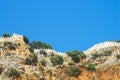 Stone fortress on a rock against the sky. Stone fence on the mountain