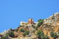 Stone fortress on a rock against the sky. Stone fence on the mountain