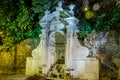 Stone fountain Prigione autumn night in Rome, Italy