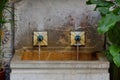 Stone fountain with two water pipes Royalty Free Stock Photo