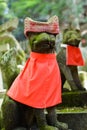 Stone fox statue with red cap. Royalty Free Stock Photo