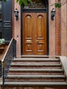 old urban brownstone type townhouse with polished double wooden door