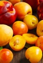 Stone fruits on wooden background. Yellow plums, apricots and nectarines Royalty Free Stock Photo