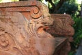 A stone garden bench with mythological creature sculptures