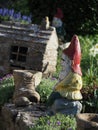 a stone garden gnome in close-up in a lovely garden Royalty Free Stock Photo