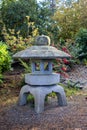 Stone garden lantern in the sunlight Royalty Free Stock Photo