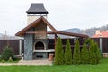 Stone garden oven for grill or barbeque is in a backyard Royalty Free Stock Photo