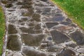 A stone garden path made of rock of different shapes paved into a wet path. Royalty Free Stock Photo