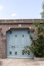 stone garden wall and blue vintage garden gate. Royalty Free Stock Photo