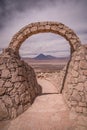 Stone gate at Pukara de Quitor - Inca fortress at Atacama desert with the view at Licancabur volcano in Andes, San Pedro de Atacam